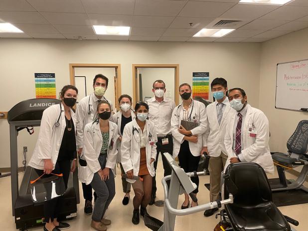 Group of students in white coats and masks in hospital
