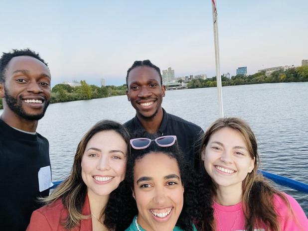 Five students on boat cruise, smiling